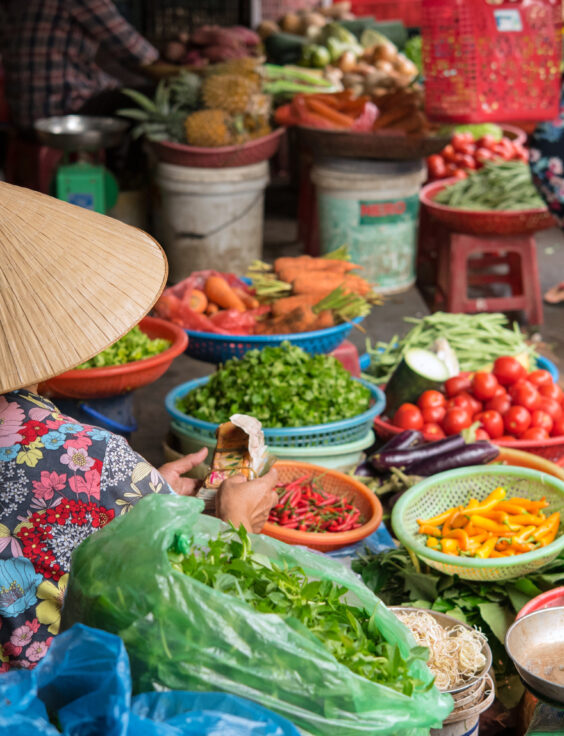 Vietnamese woman selling vegetables at market in Hoi An　ベト